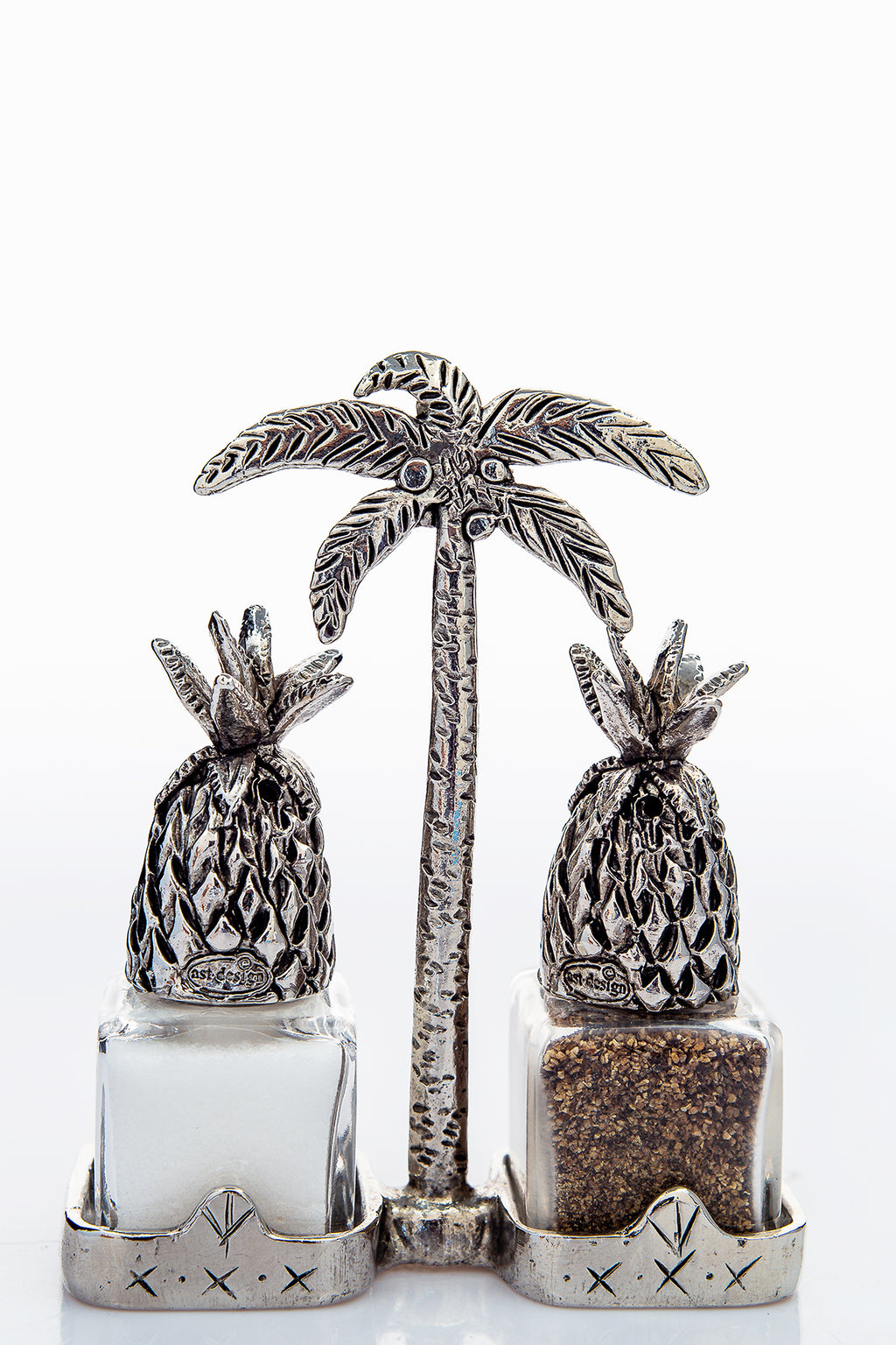 Pineapple salt and pepper shakers with a palm-tree carrier, handcrafted by German artist Thomas Leiblein. American pewter, made in the USA.