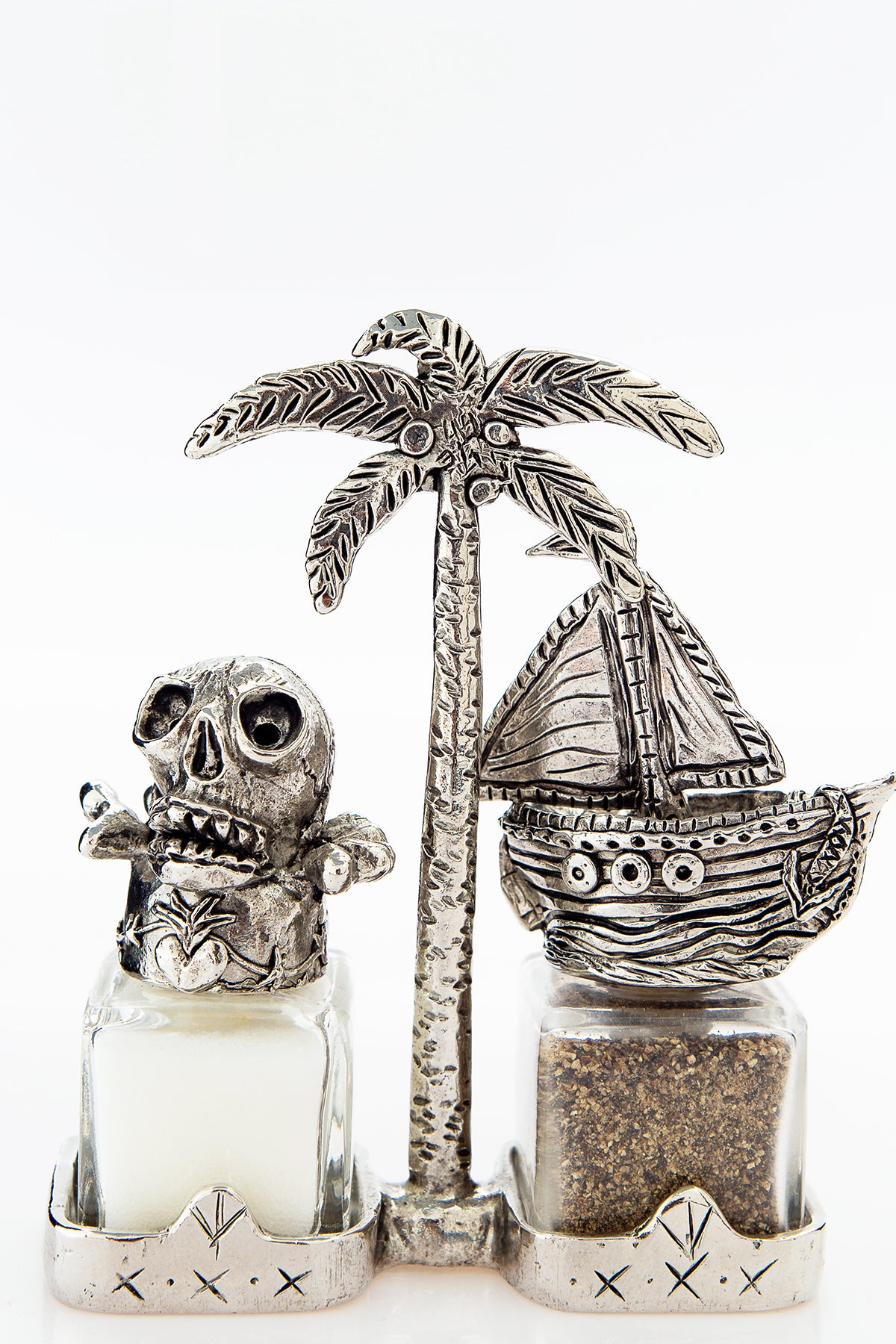 Skull and Ship salt and pepper shakers with a palm-tree carrier, handcrafted by German artist Thomas Leiblein. American pewter, made in the USA.